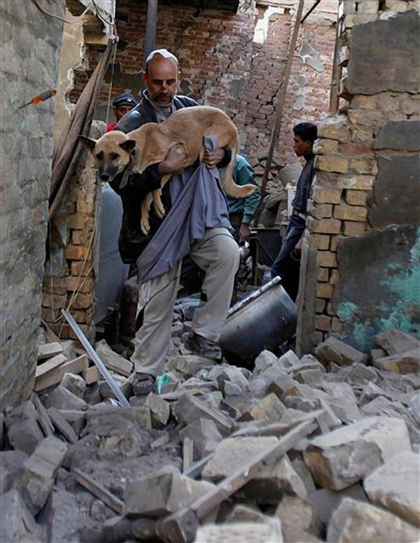 Faroug Omar rescues his dog, Liza in Baghdad, Iraq, Wednesday, Dec. 9, 2009. (AP Photo/Hadi Mizban)