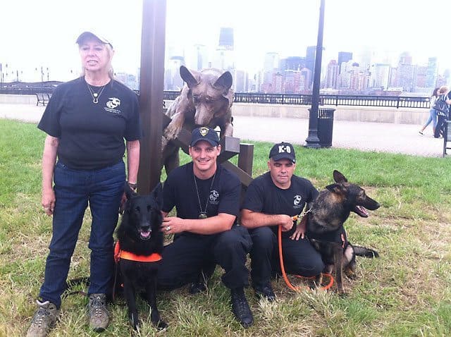 Dog Teams in front of statue